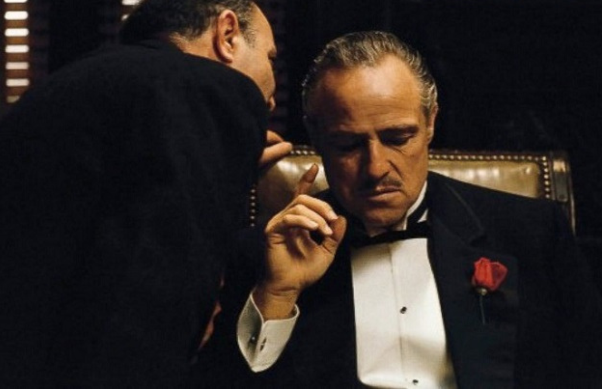 The baker whispering to Don Corleone in his office
